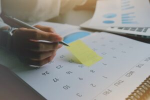 writing financial tasks on calendar
